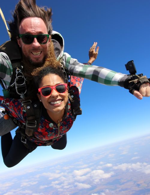 Tandem parachute jump. Beautiful Brazilian woman.